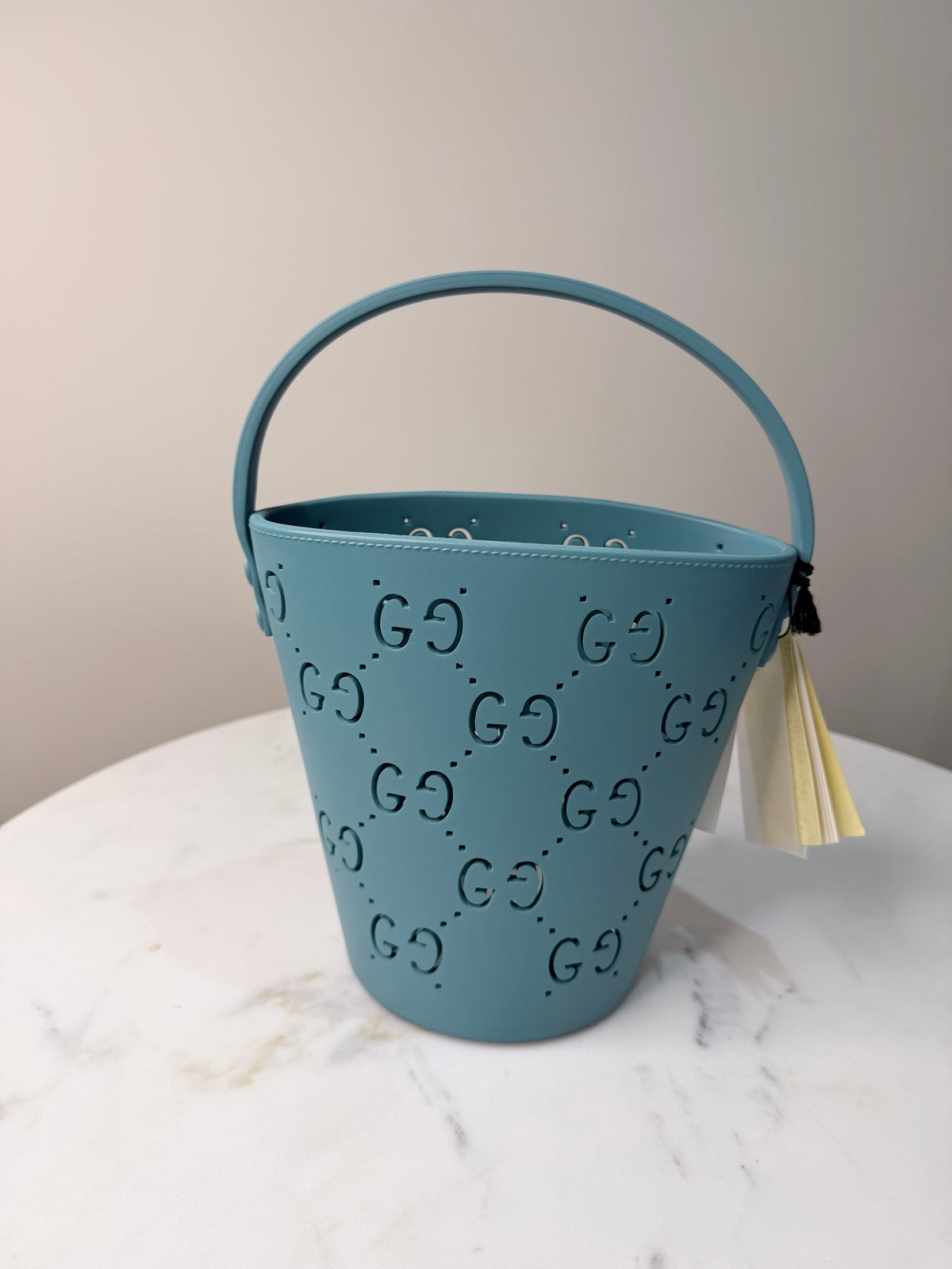 A light blue Gucci bucket bag with GG monogram pattern