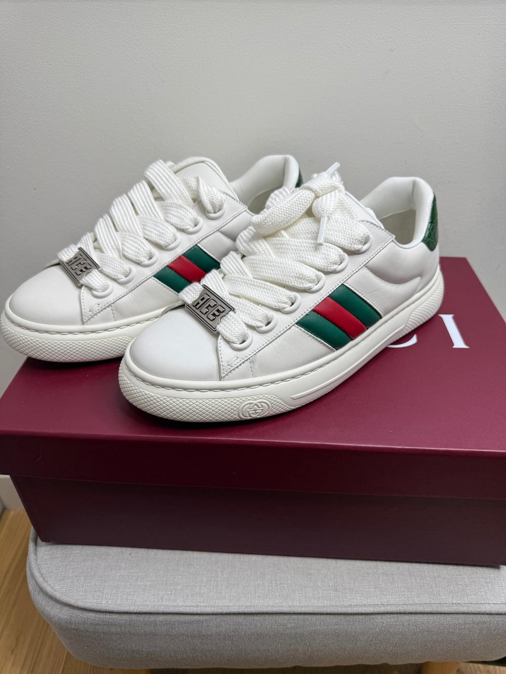 Angled view of Gucci Ace women’s white leather trainers with green and red web stripe size EU 38