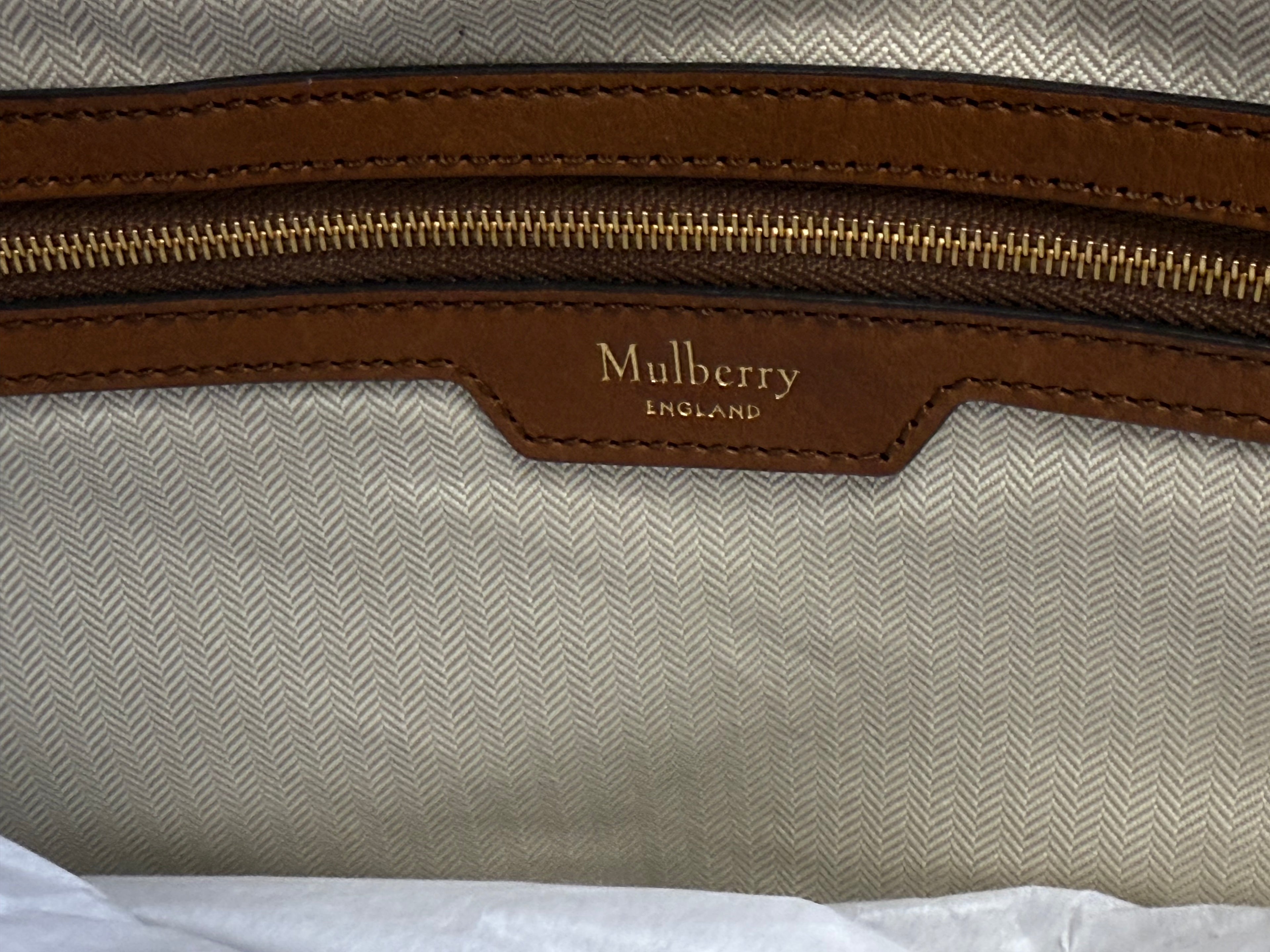 Top closure detail on Mulberry canvas tote with leather trim
