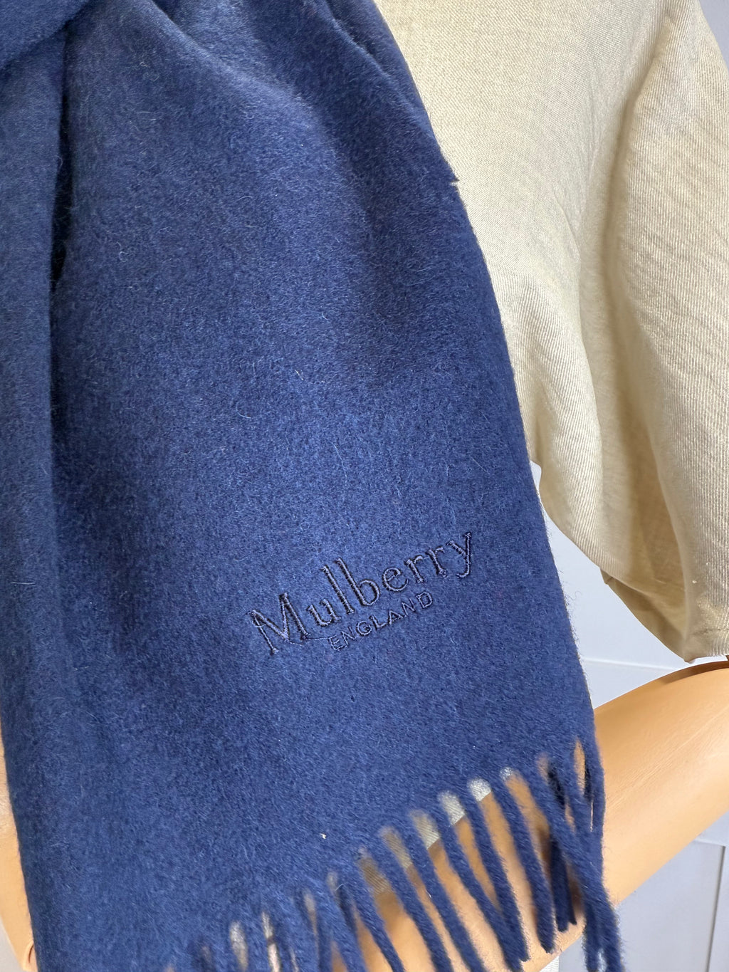 Flat lay of Mulberry navy blue merino wool scarf
